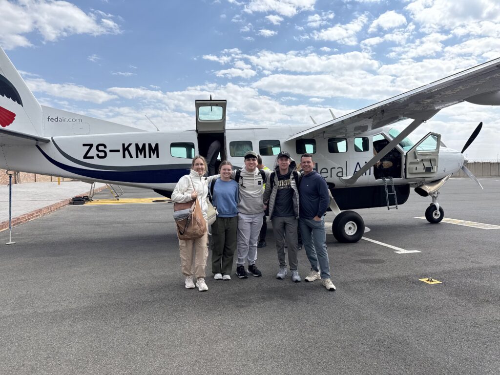 Family boarding a charter plane to begin their luxury South Africa safari.