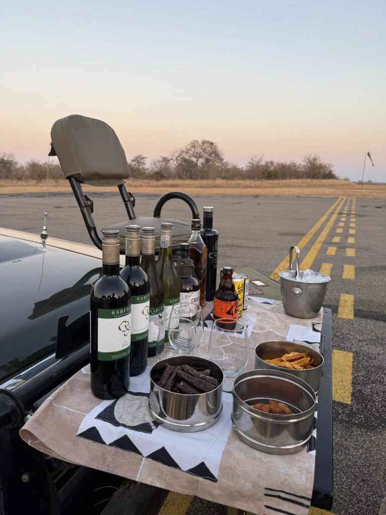 Traditional safari sundowners with wine and snacks in the South African bush.